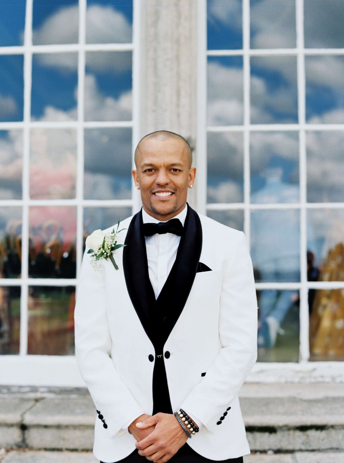 A wedding photo of the groom posing for a photo at Luttrellstown Castle in Ireland