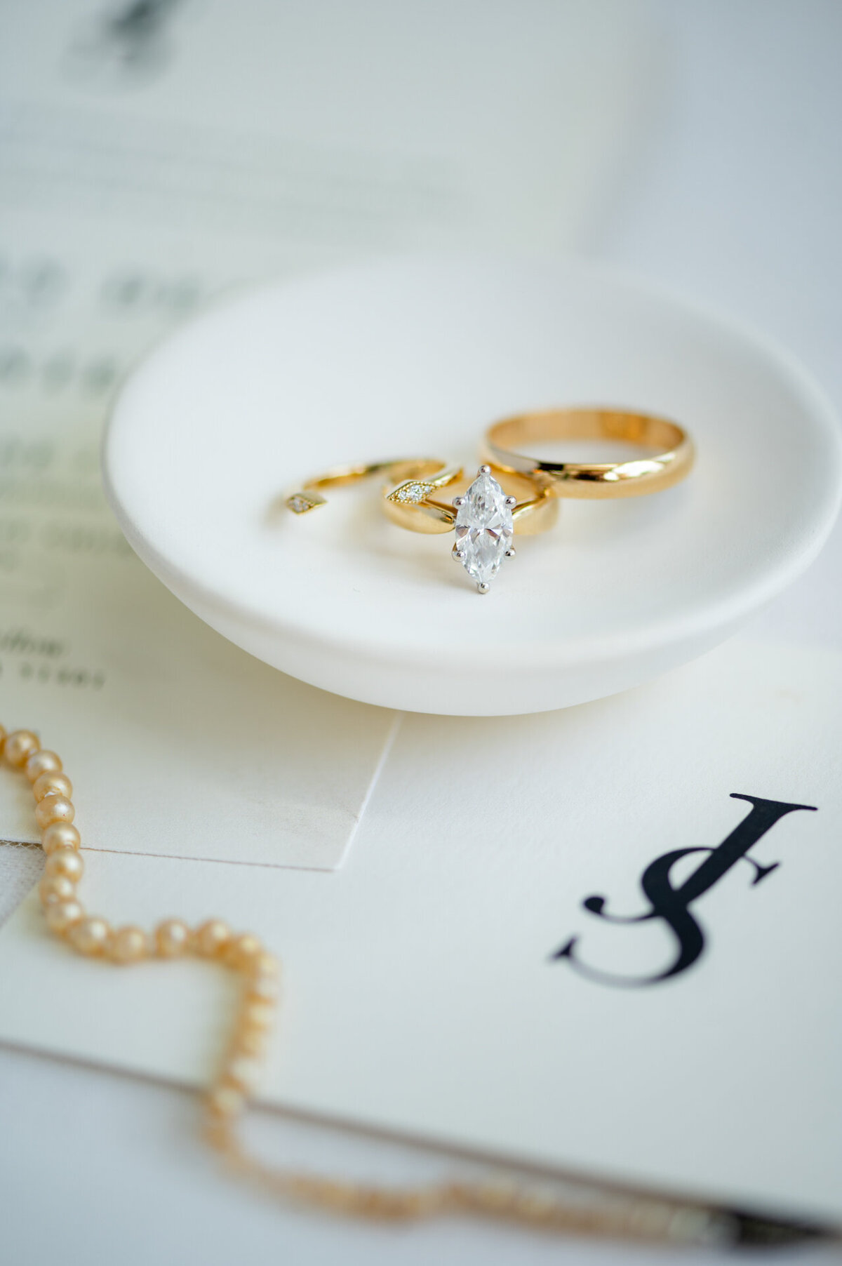 wedding rings are placed on a ring dish