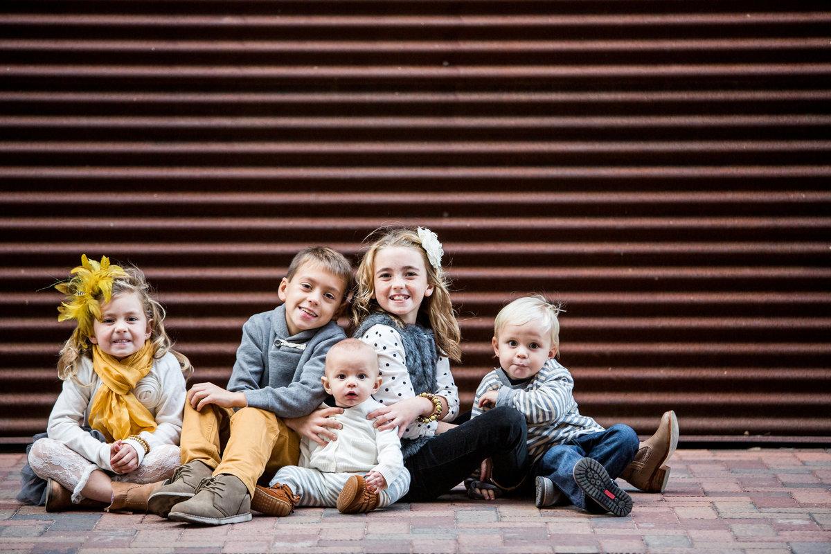 children in front of corrugated wall for family photography taken by San Antonio Photographer Expose The Heart Photographer