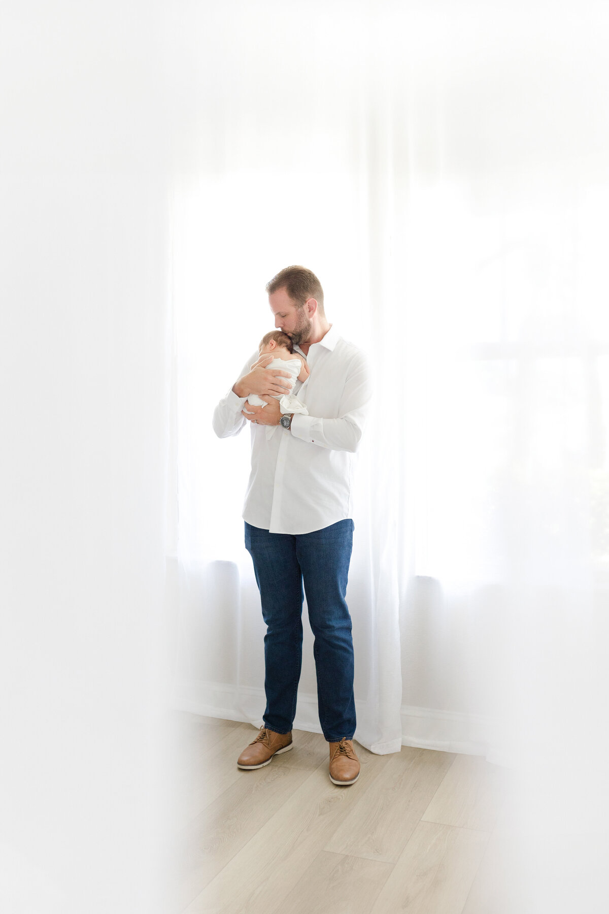 Luxury Tampa newborn portrait in natural light studio with soft neutral tones and soft light