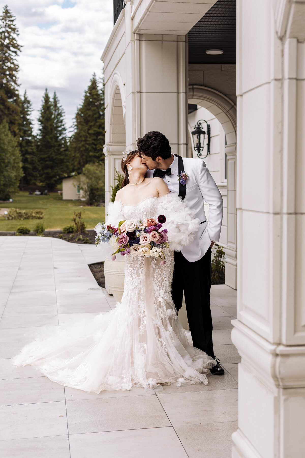 Couple kisses outside of Archway Manor