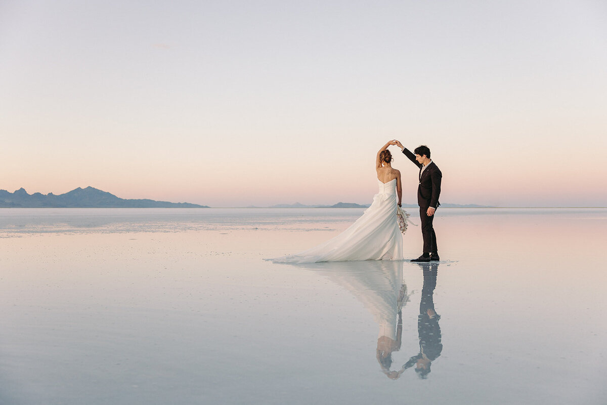 Utah Wedding Photographers capture bride and groom dancing at Salt Flats after elopement