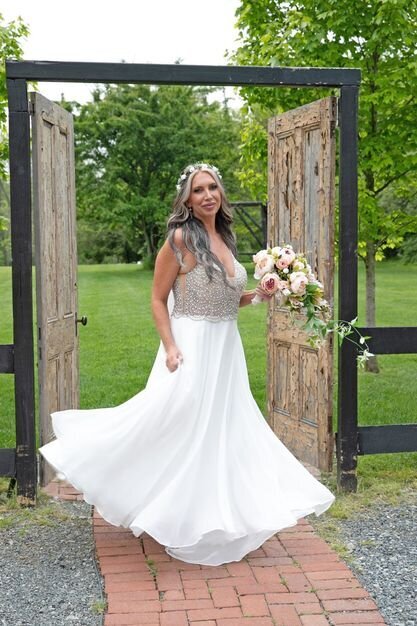 Lovely bride in her white sparkly wedding gown in a garden.
