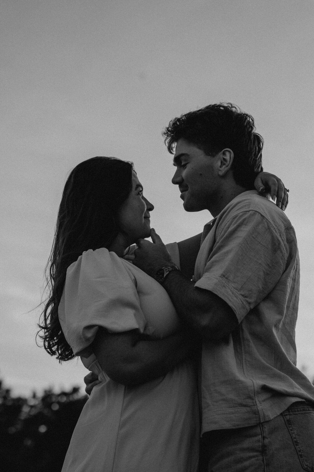 Couple's engagement session in Omaha during golden hour, surrounded by warm fall foliage – captured by Tori Nichole Photography. Authentic, romantic moments in a stunning autumnal setting, reflecting the beauty of the season and their love story.