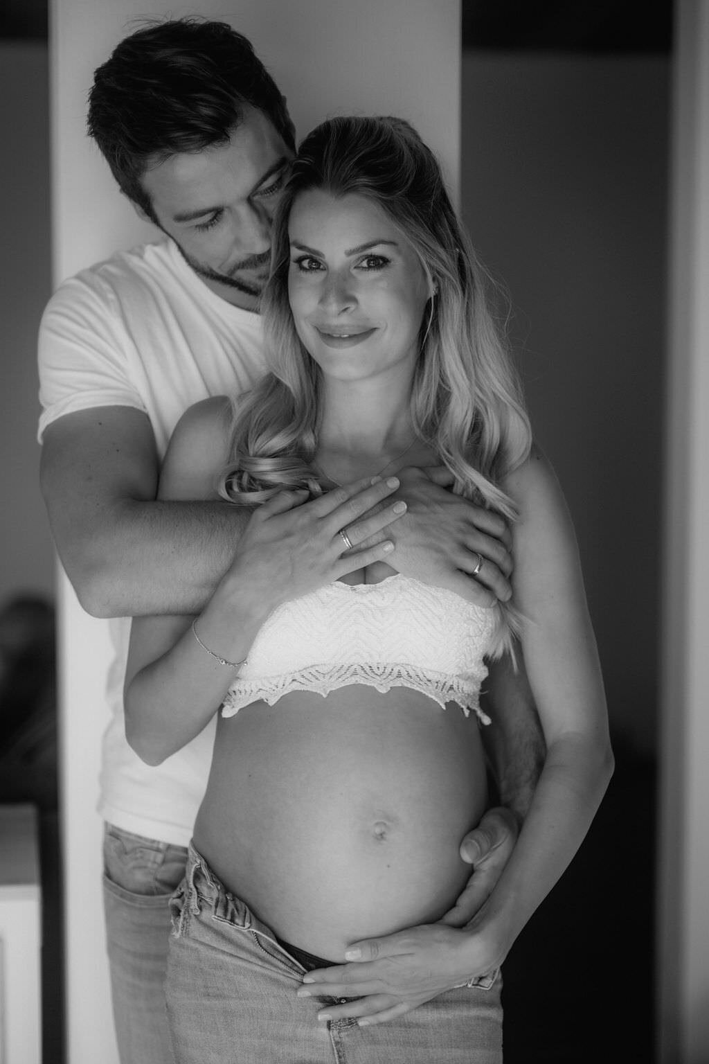 Couple picture during maternity session of the expeting couple in a close embrace.