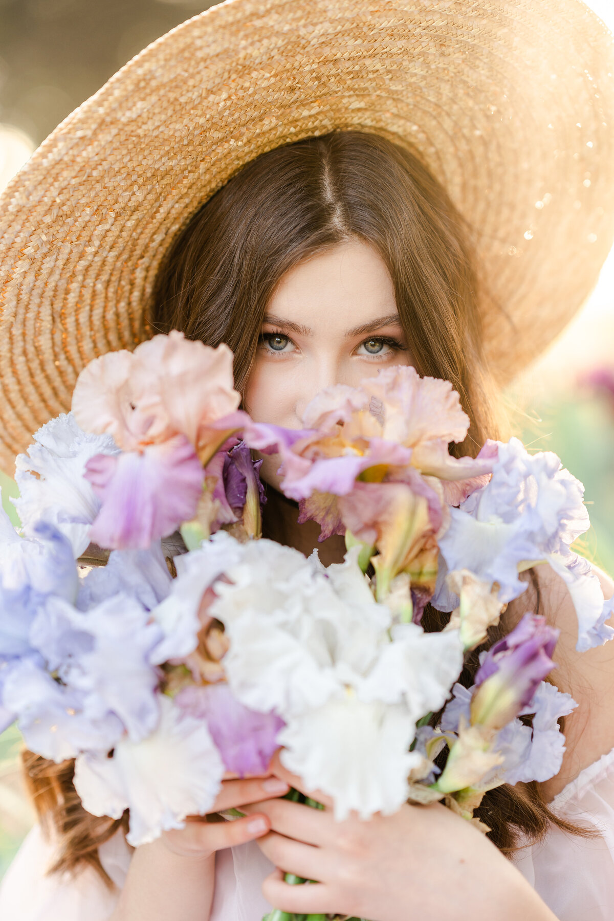 A woman holds a bouquet of iris flowers photographed by Bay area photographer, Light Livin Photography.
