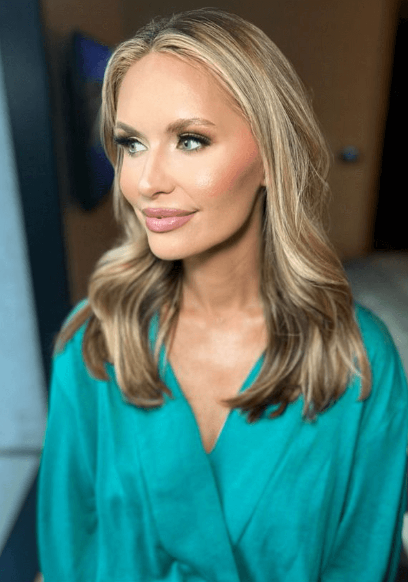 Woman with voluminous curls and glowing skin, styled for special event hair and makeup session in Austin by Mistique Makeup