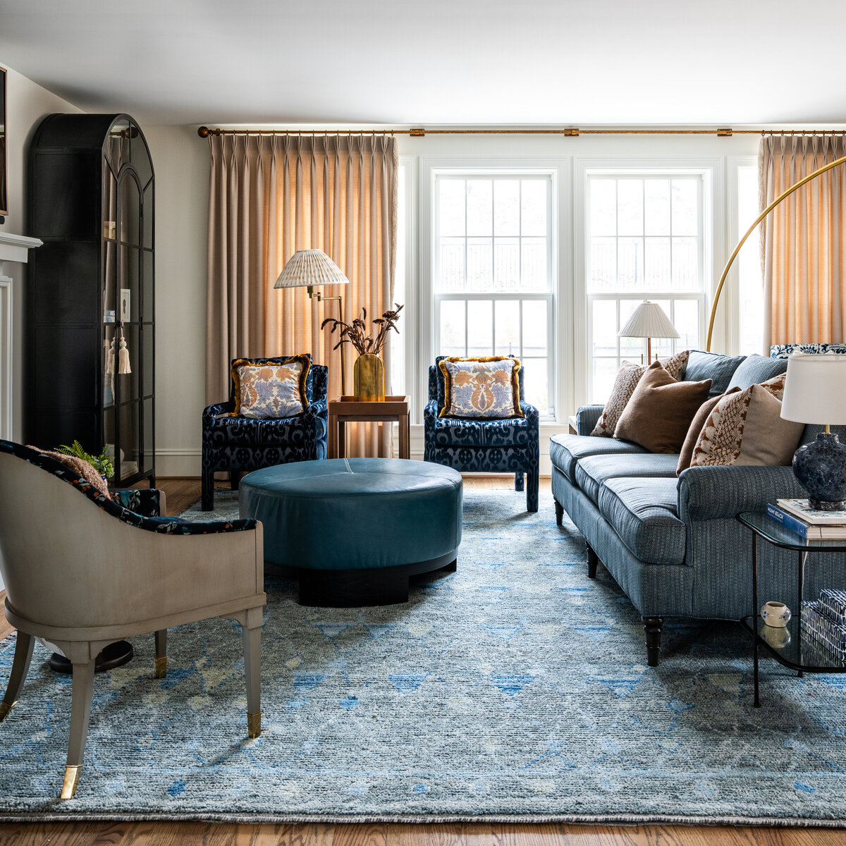 Living room with lots of pattern and layering and blue accents