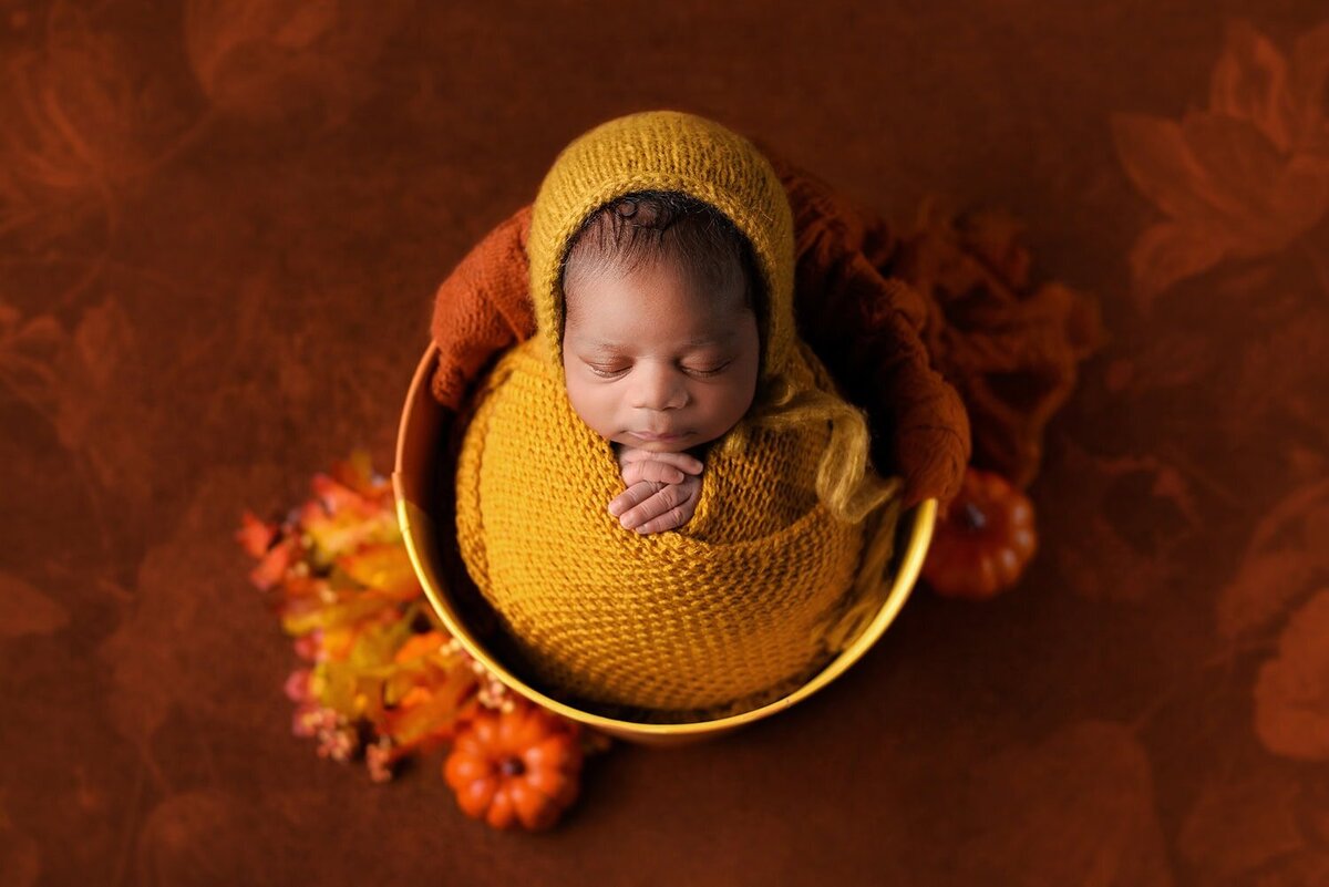 mobile-in-home-newborn-photography-vancouver-fraser-valley_baby-boy-yellow-orange-bucket-wrap-fall-pumpkins