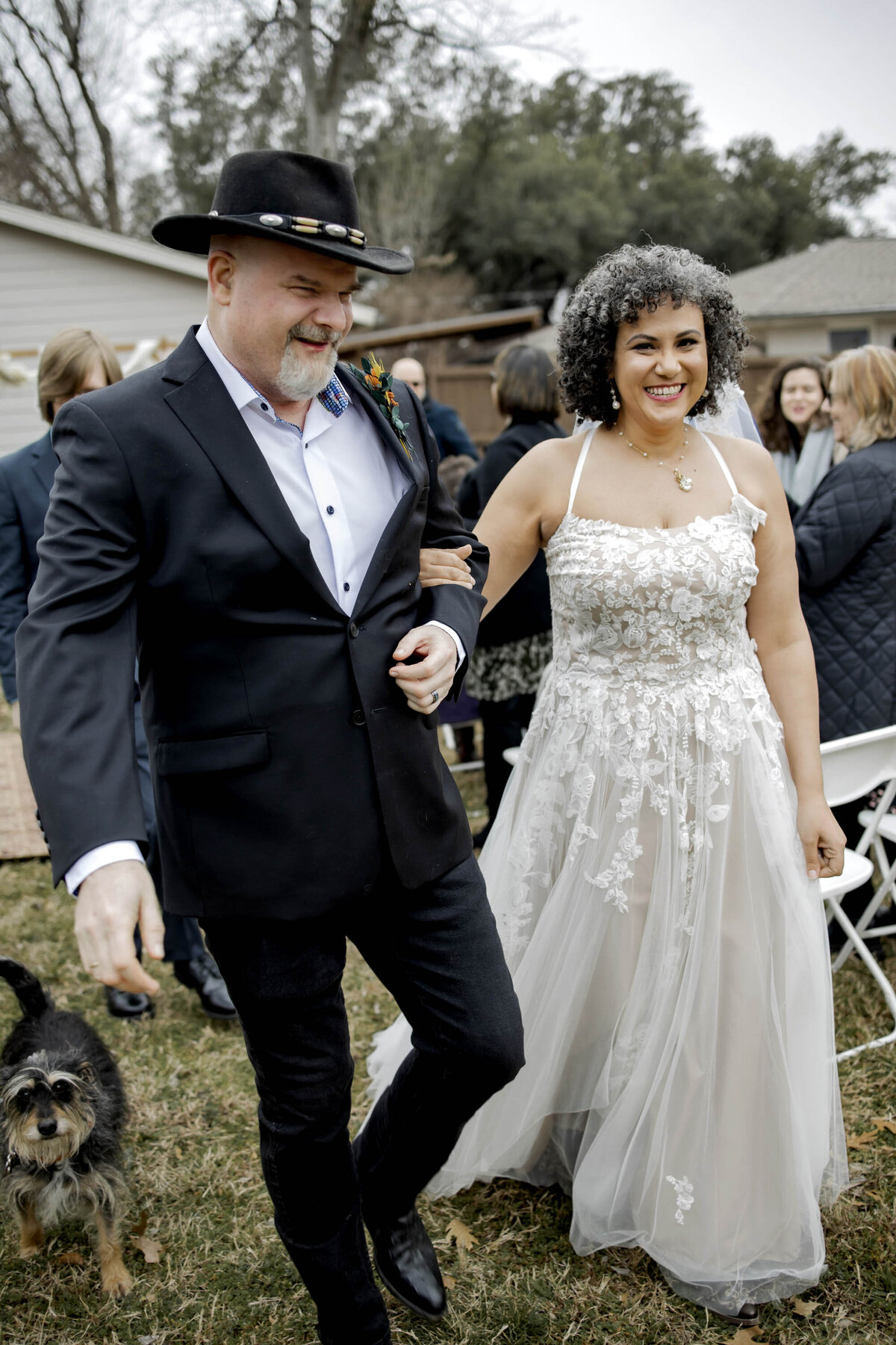 a married couple at their small backyard wedding