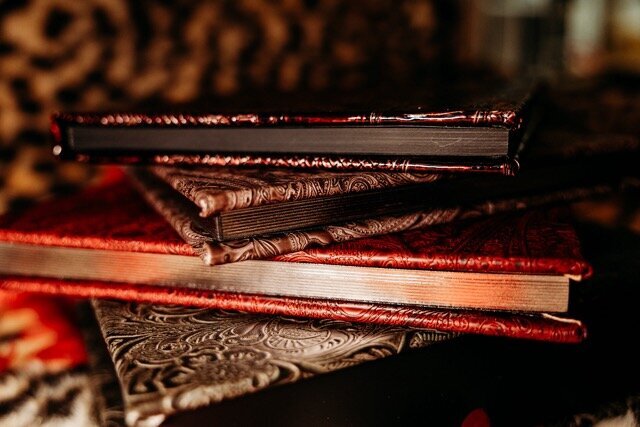 Boudoir photography three keepsake albums on leopard rug in Lubbock, Texas photographer in Amarillo TX