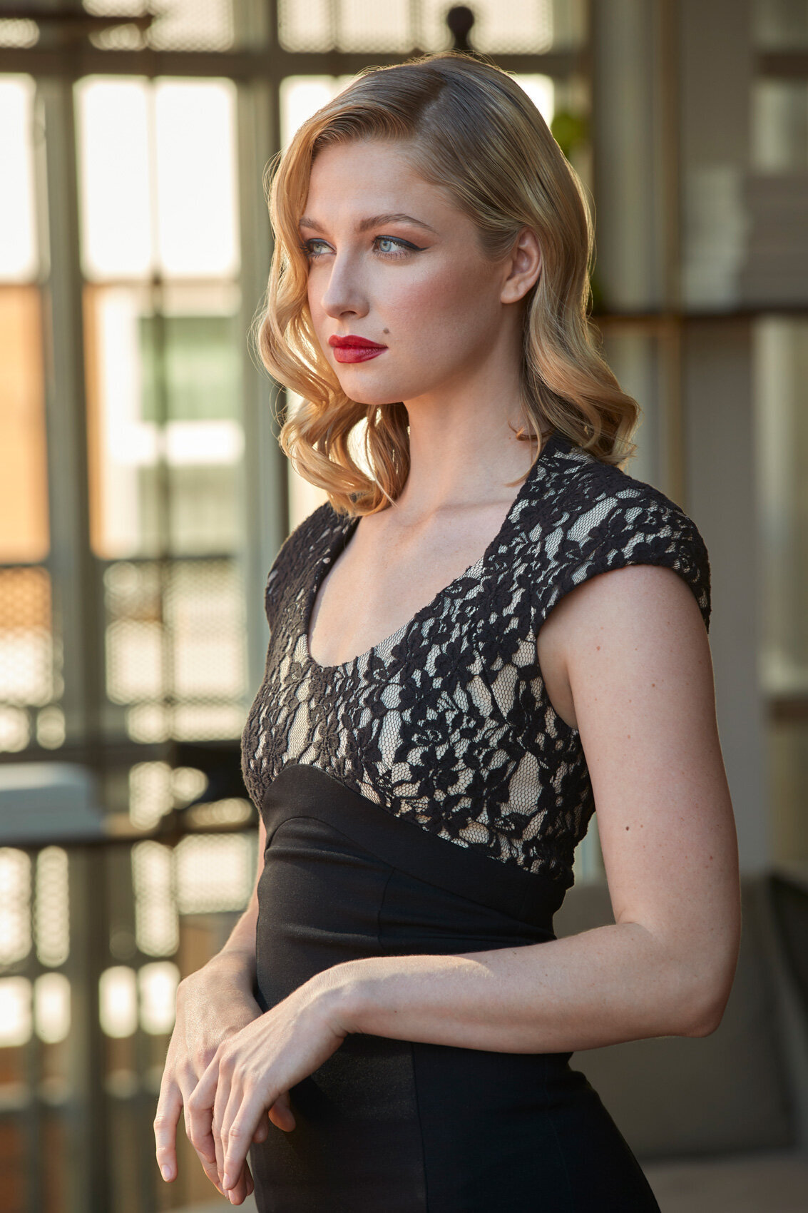 Stylish portrait of Ellie Bisping in a patterned dress, standing confidently outdoors, shot by Ylva Erevall.