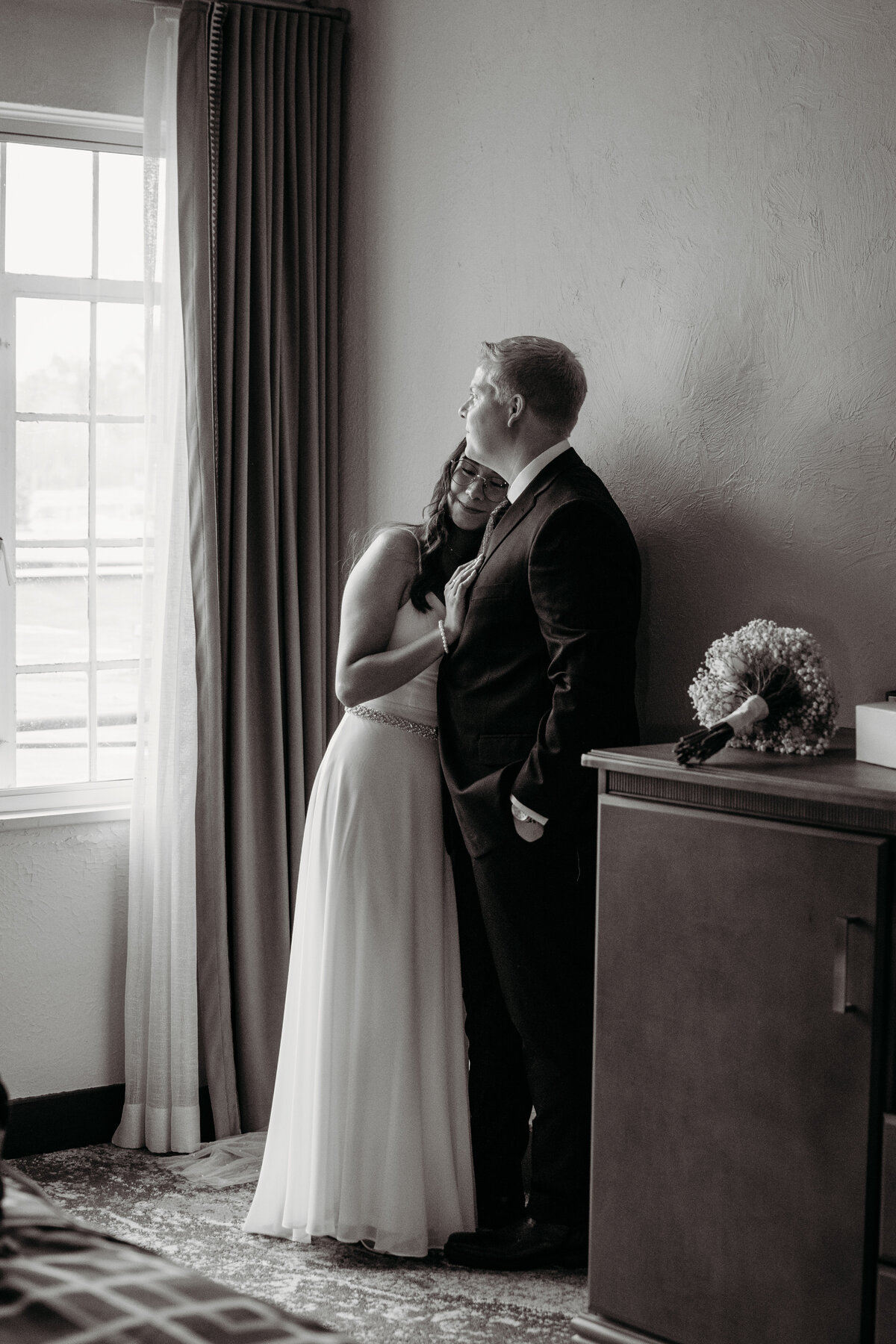 black and white photo of a bride and groom during their first look at Hotel Baker, St. Charles, IL