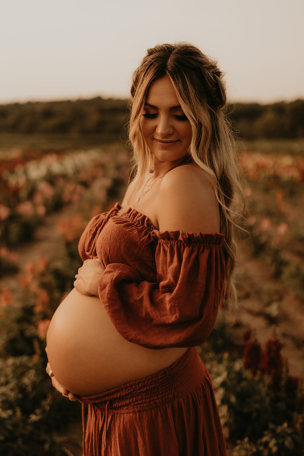 Sunset maternity photography in a flower field