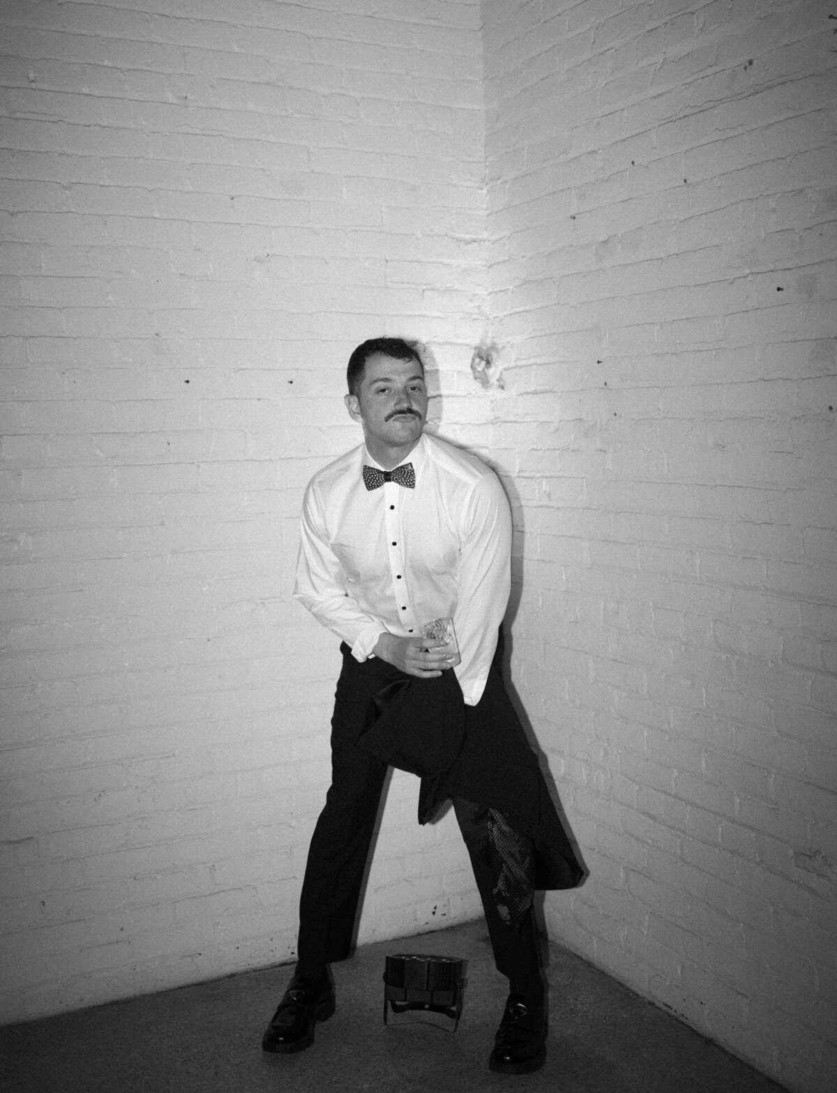 a wedding guest poses at a warehouse afterparty in Detroit