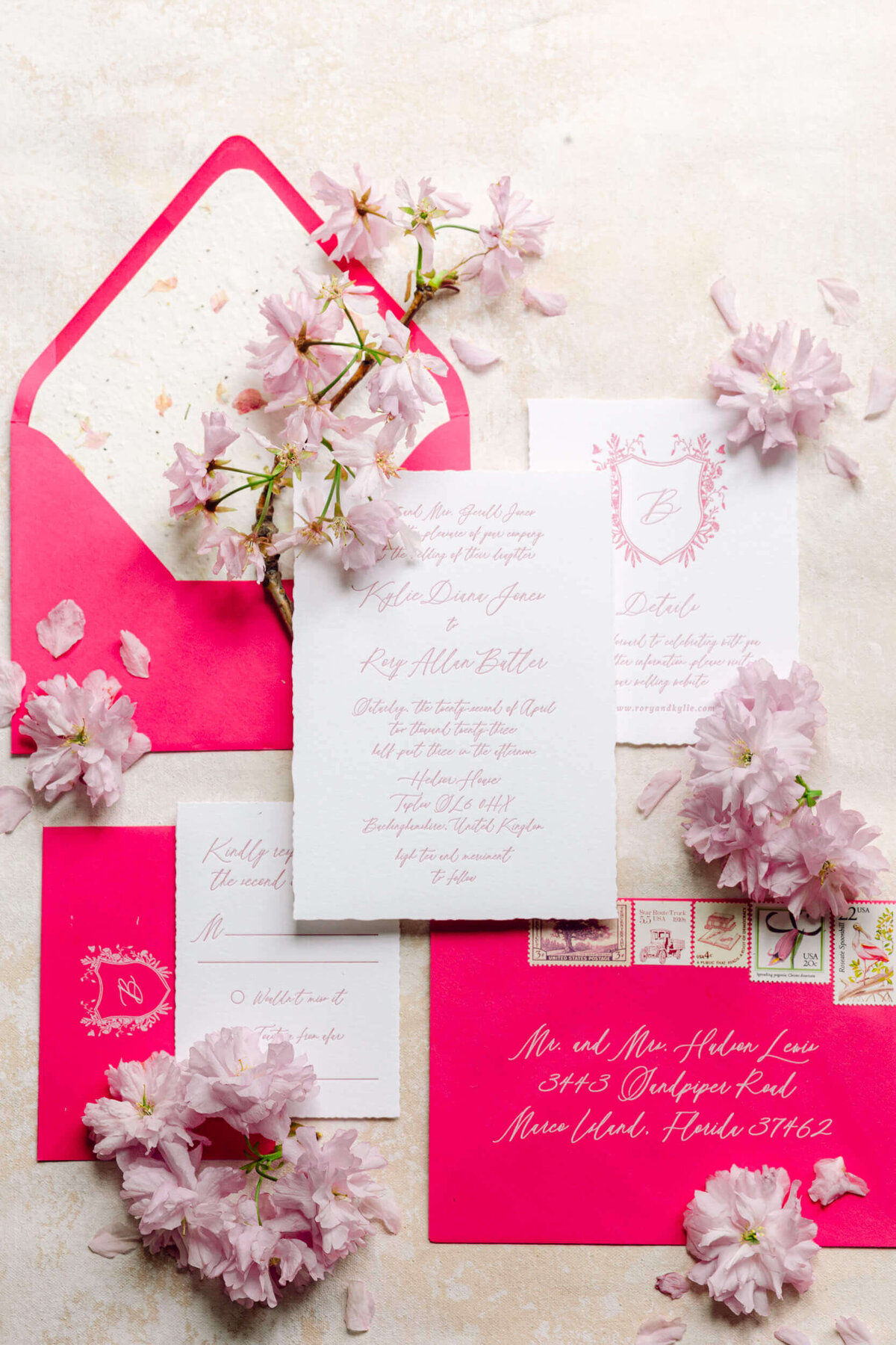 A wedding day photo of the brides pink wedding invitations at Hedsor House in the UK