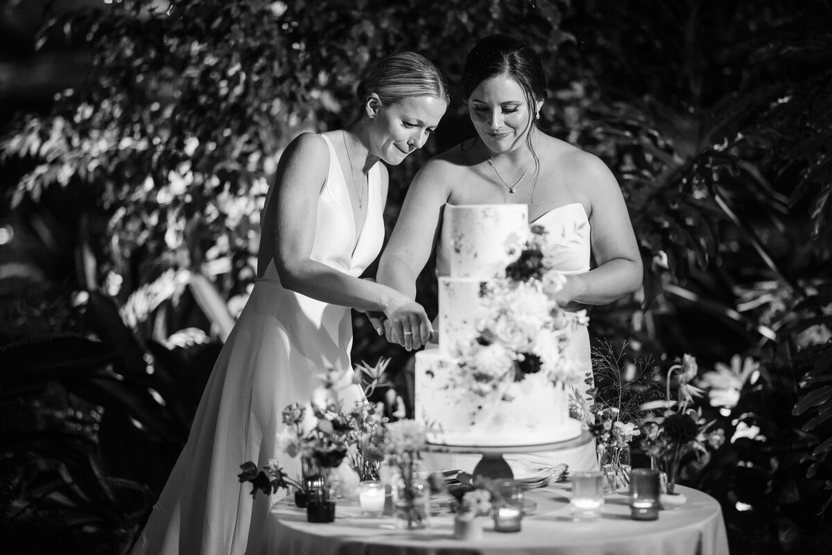 A couple cuts a cake  at a  Fairmount Park Horticulture Center wedding