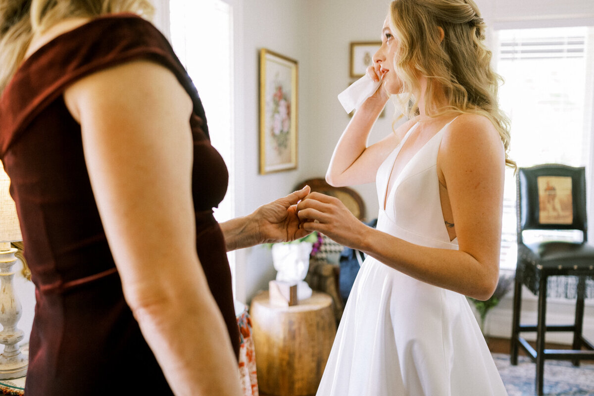 women-holding-hands-while-crying