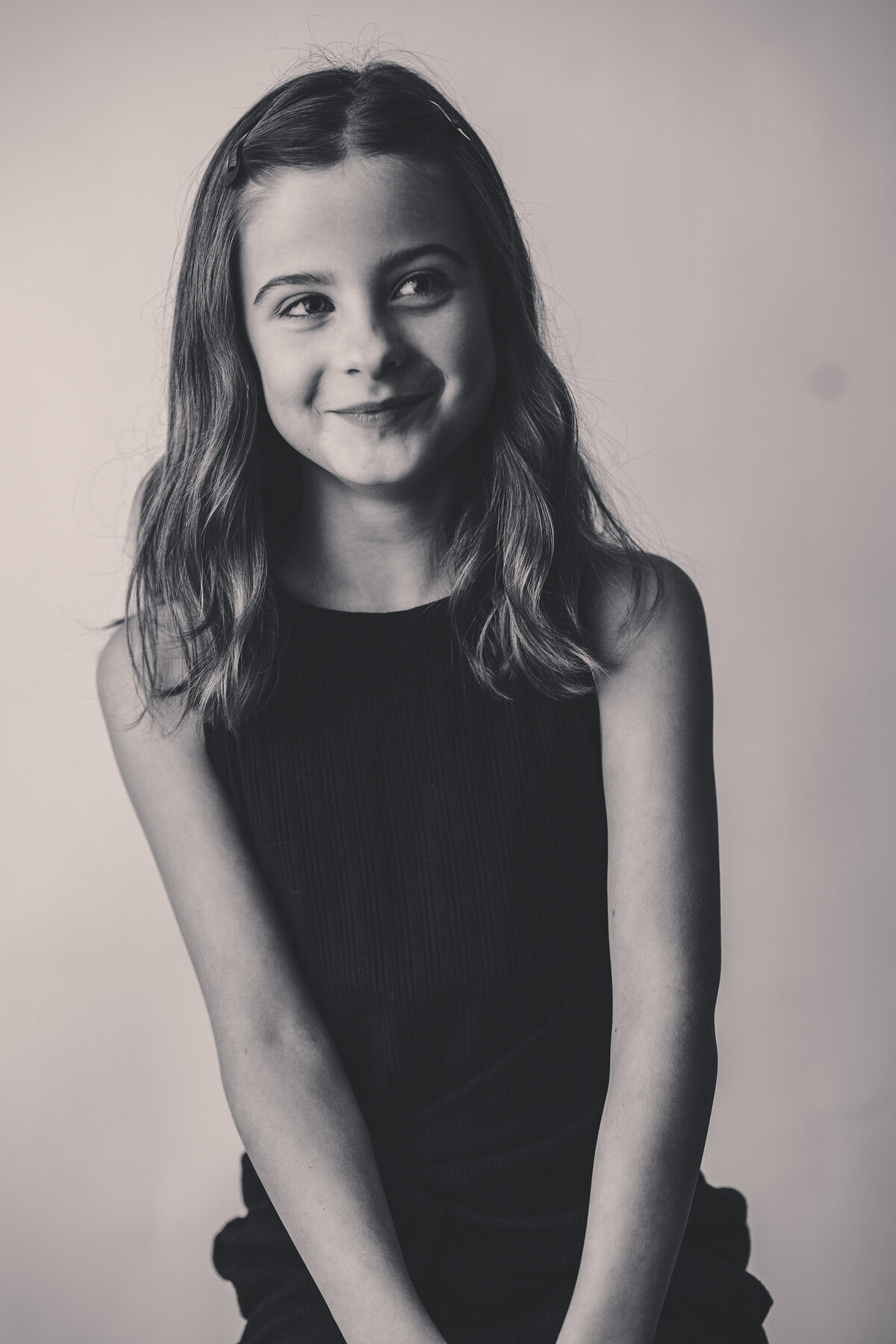 Young girl laughs off camera during Personality Portrait Session in Charleston, SC.