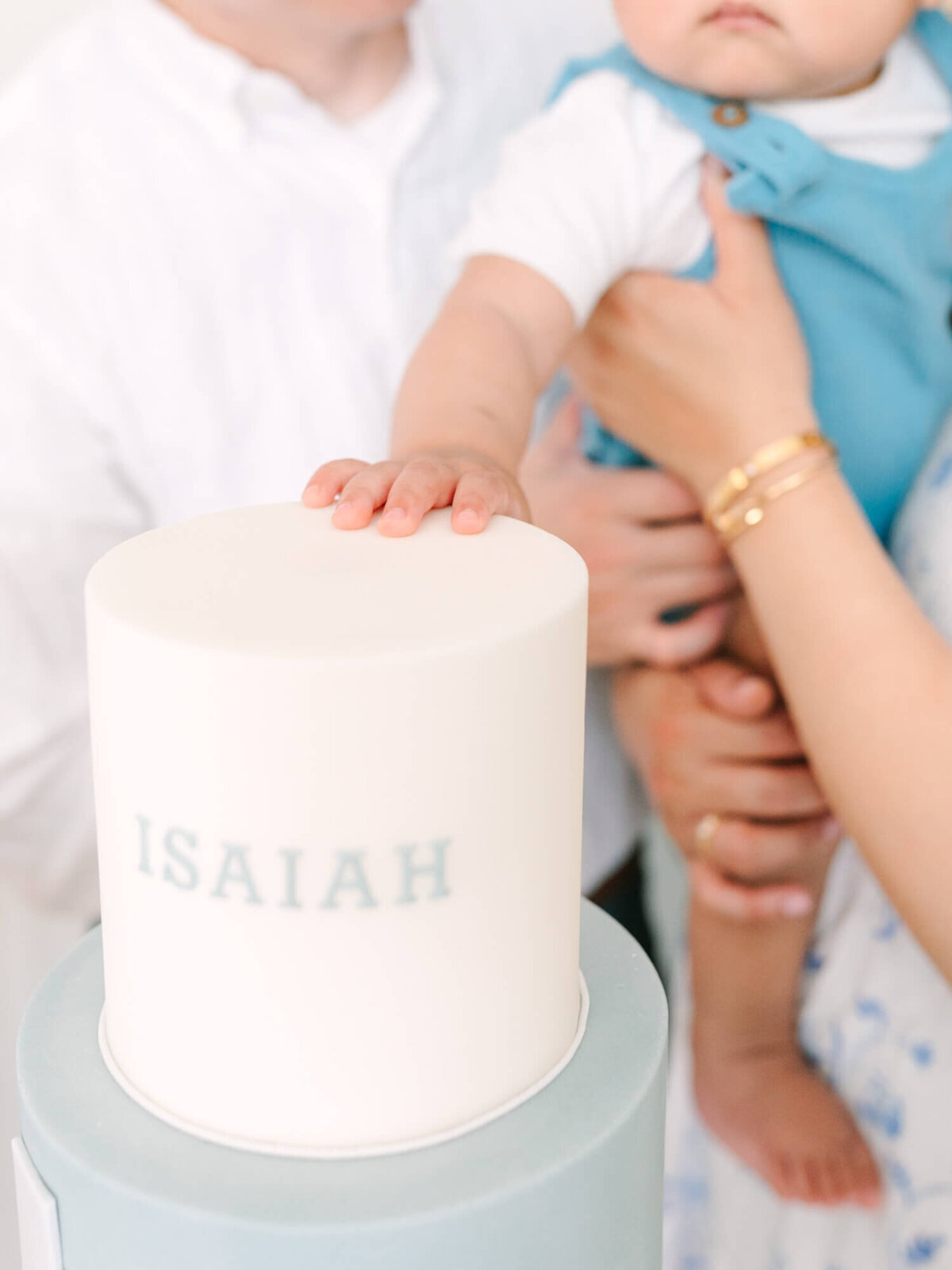 toddler's smash cake with isaiah written on it