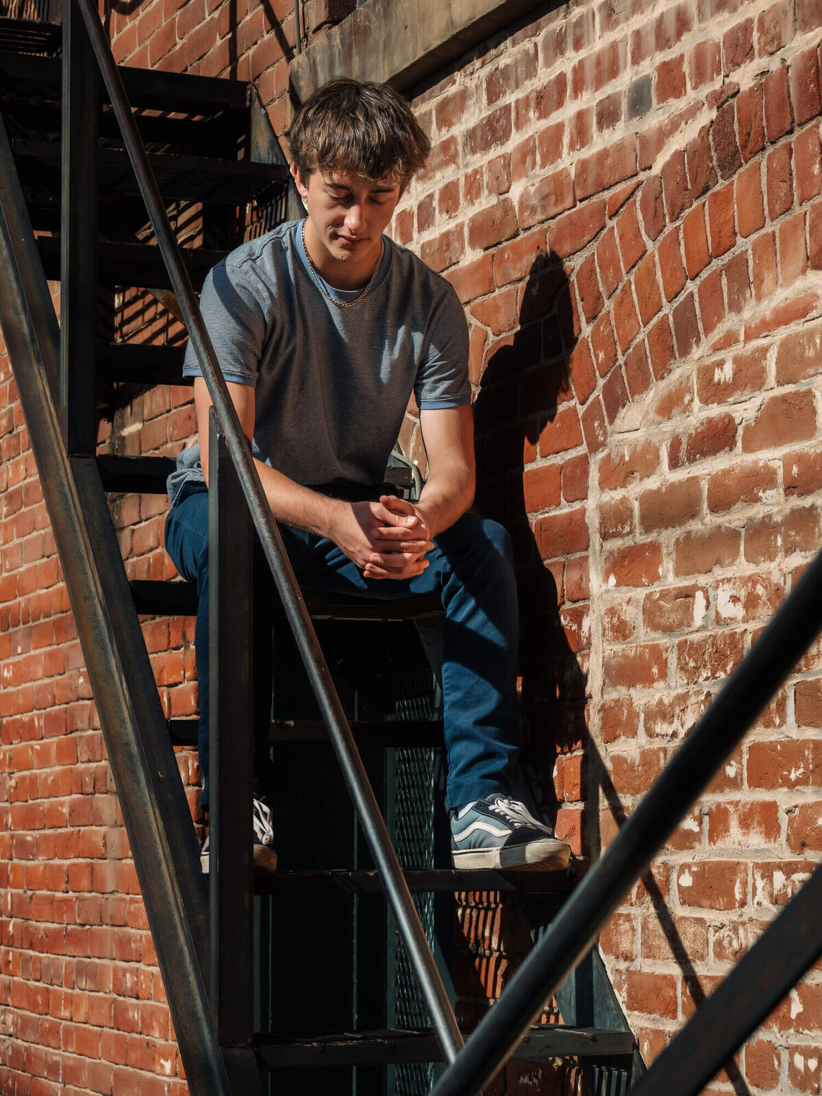 Boy poses downtown on steps in Prescott senior photos