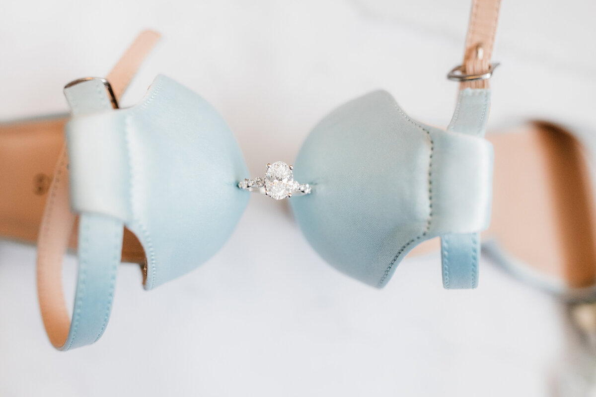 Close-up of blue wedding earrings displayed on a soft white background at a South Bend wedding.