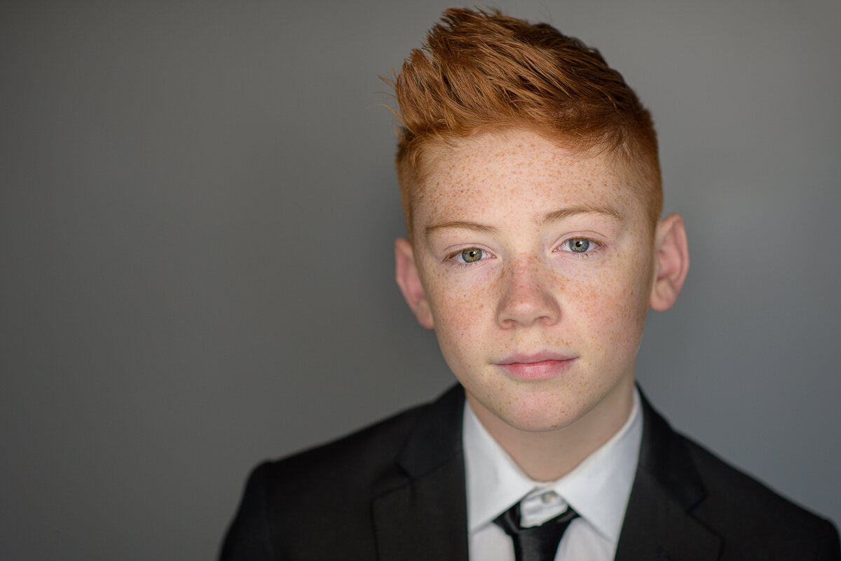 Tween boy in suit and tie in Boise photography studio.