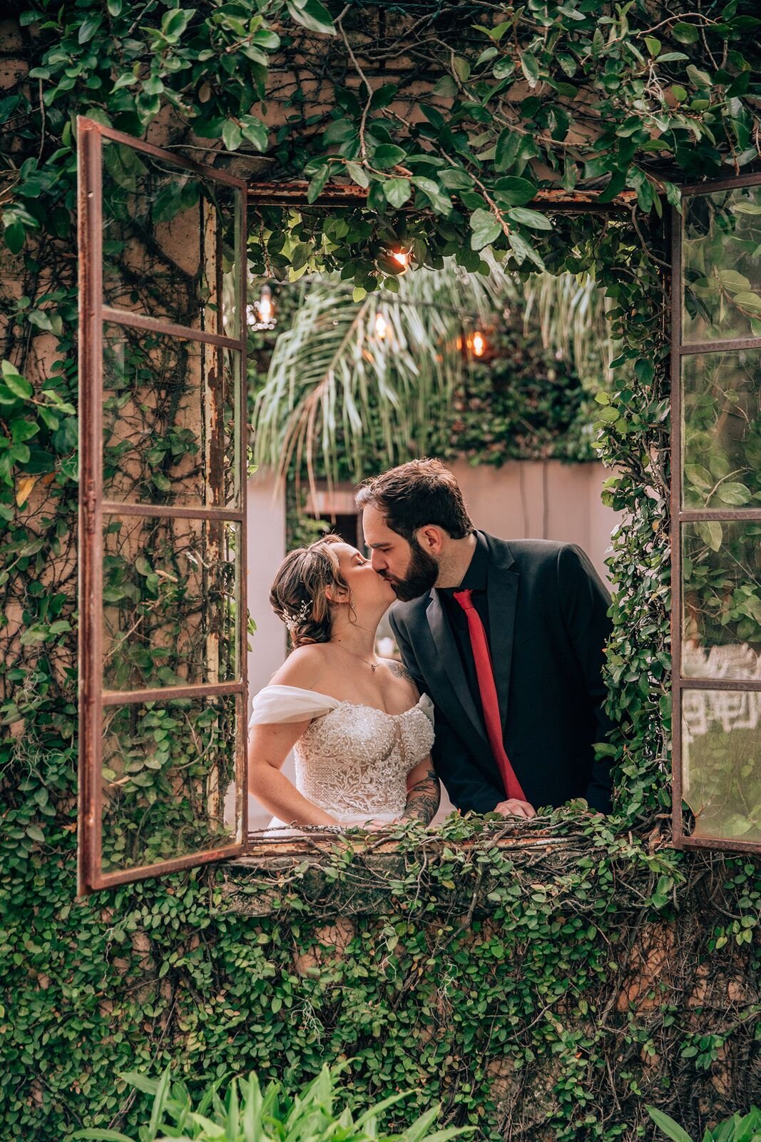 editorial photos of bride and groom through window at the acre orlando