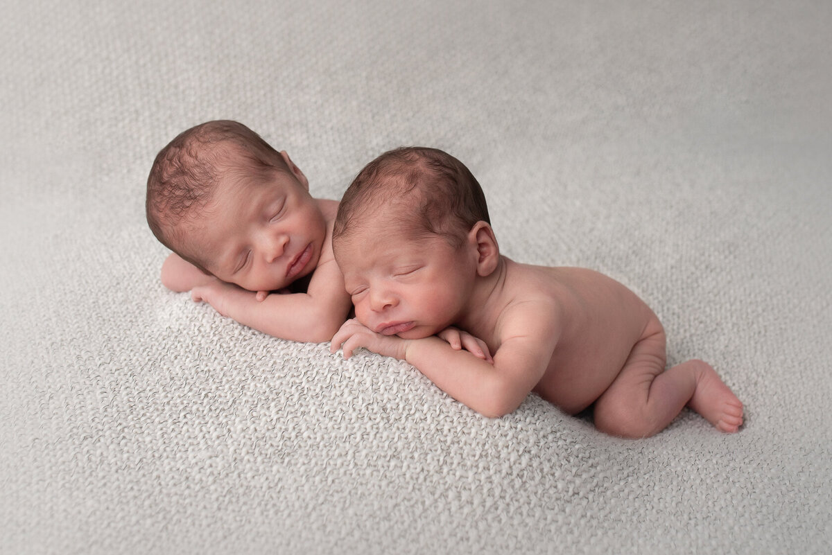 Chin on hands newborn twin photo  in Houston