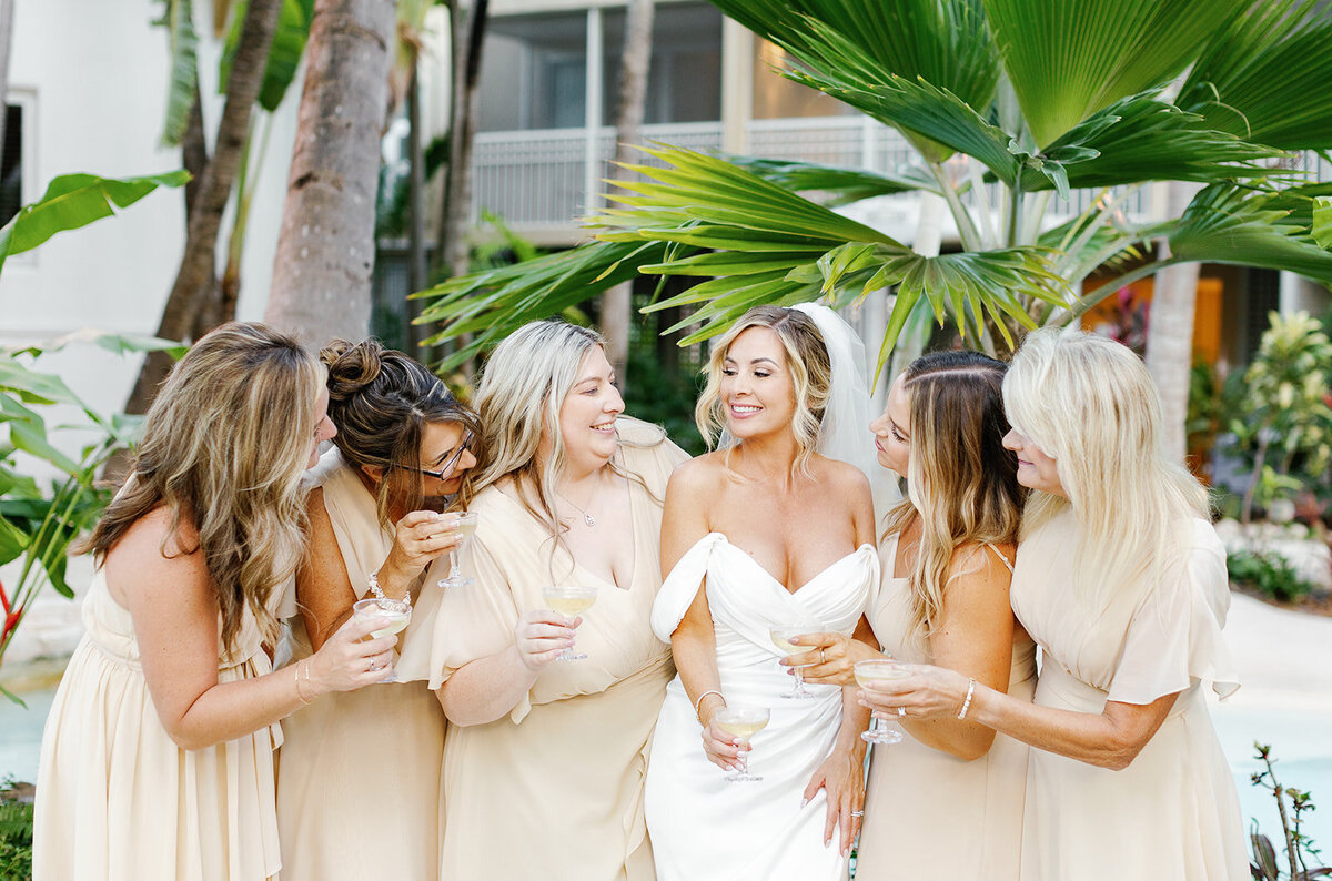 Monica and her bridesmaids raise their glasses in celebration at the Casitas at Cheeca wedding venue.