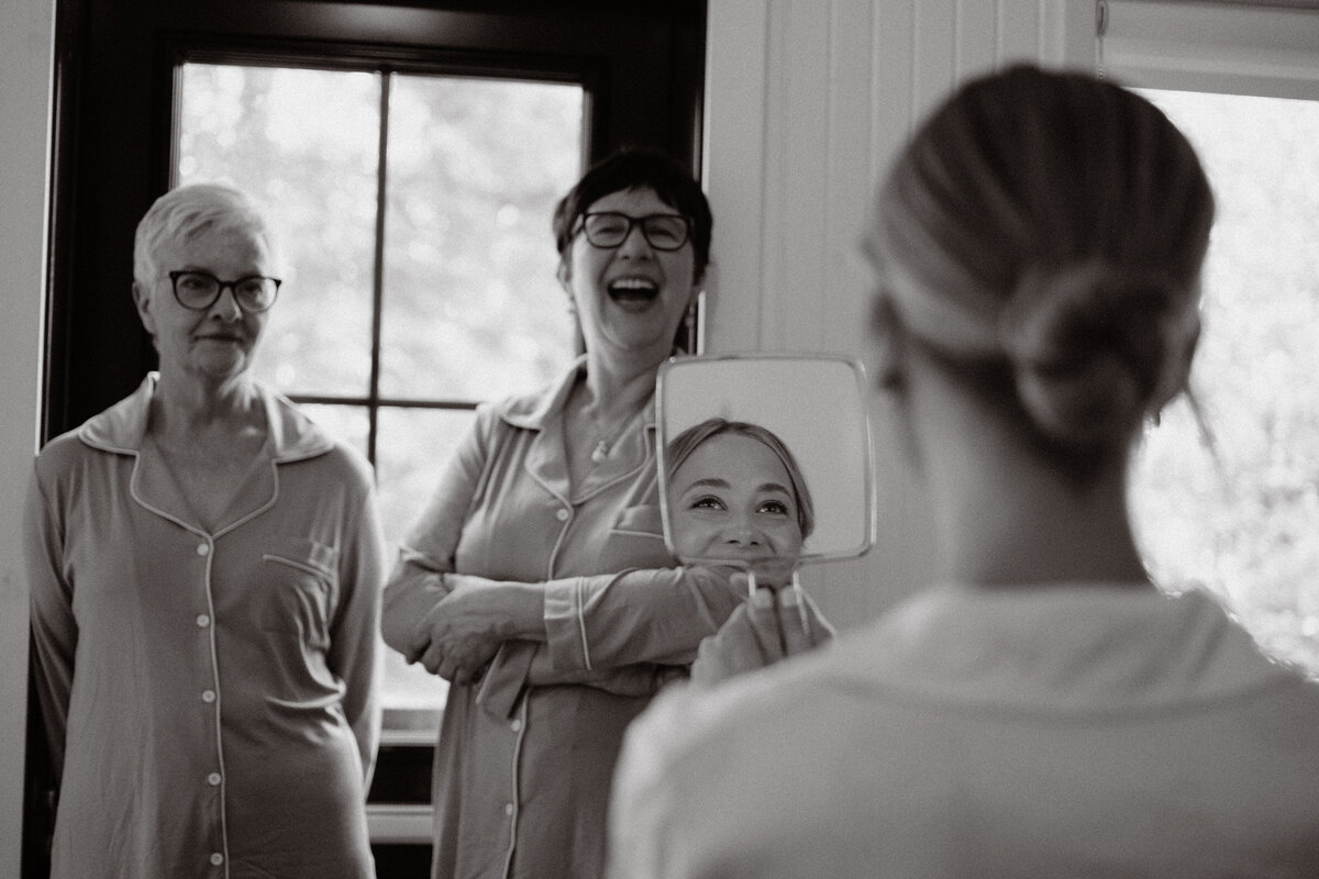 getting ready with mother of groom and mother of bride laughing with eachother