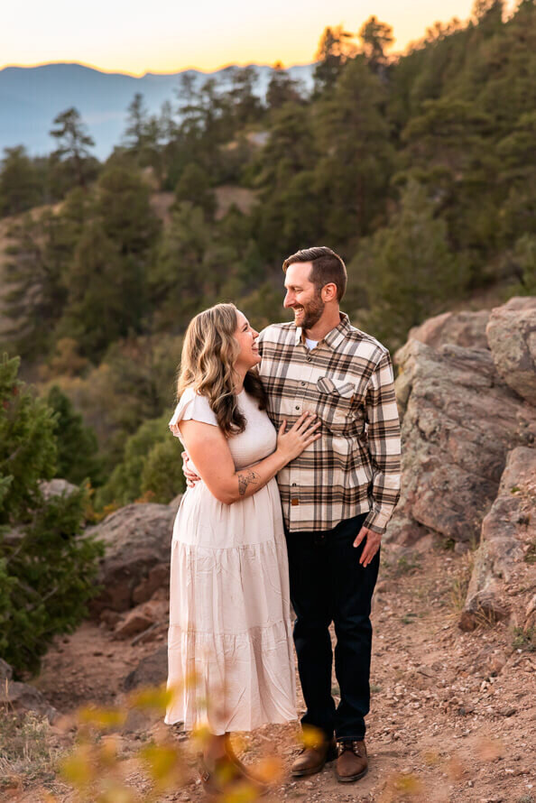 A man and woman hug and loot at each other at Mt. Falcon Park.
