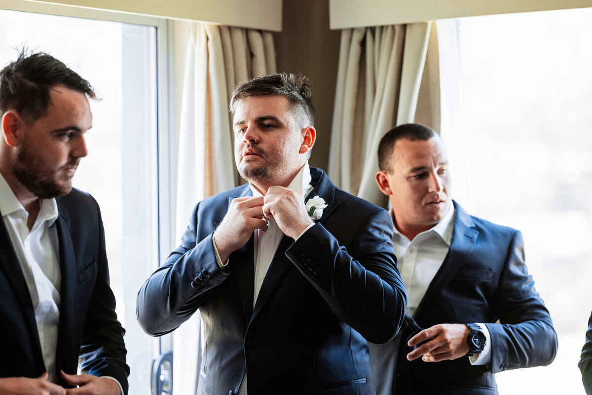 Brad getting his necktie fixed before his wedding ceremony!