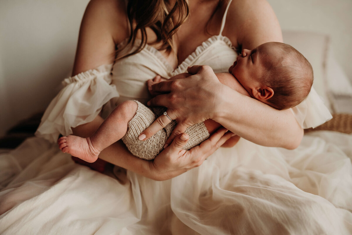 fine art newborn in his mothers arms