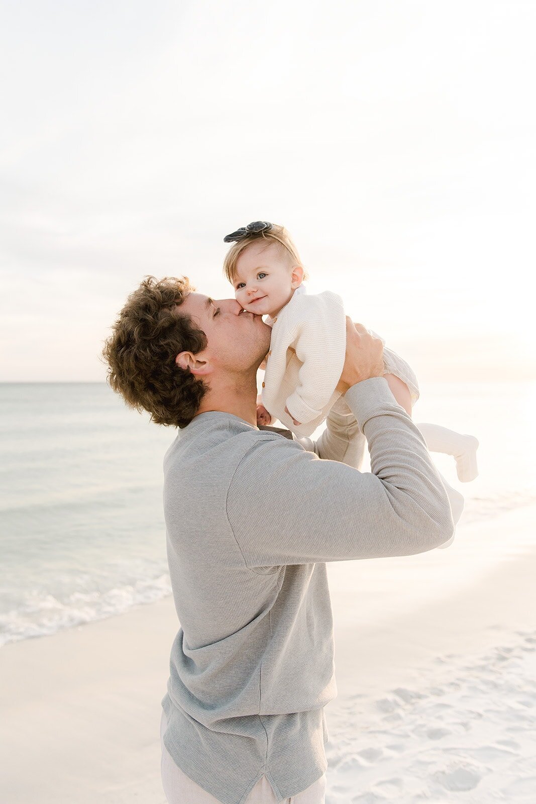 dad kissing baby on cheek by destin family photographer