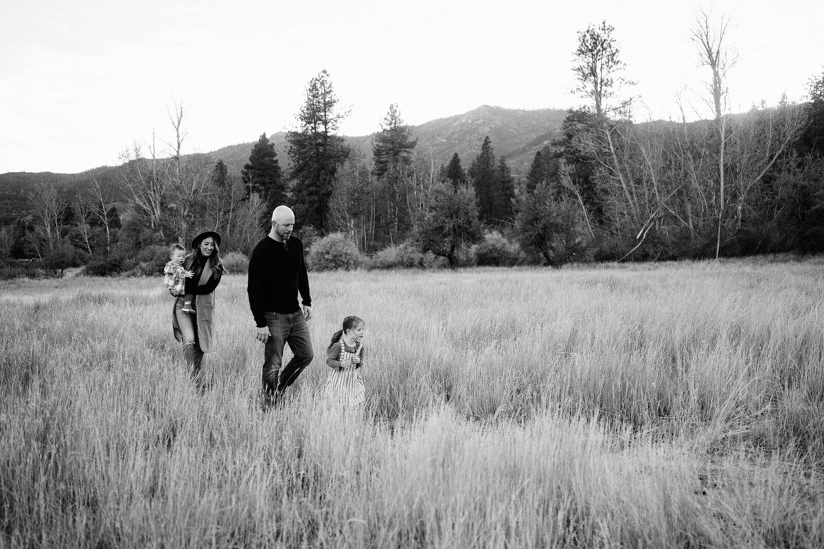 family playing in grayscale field
