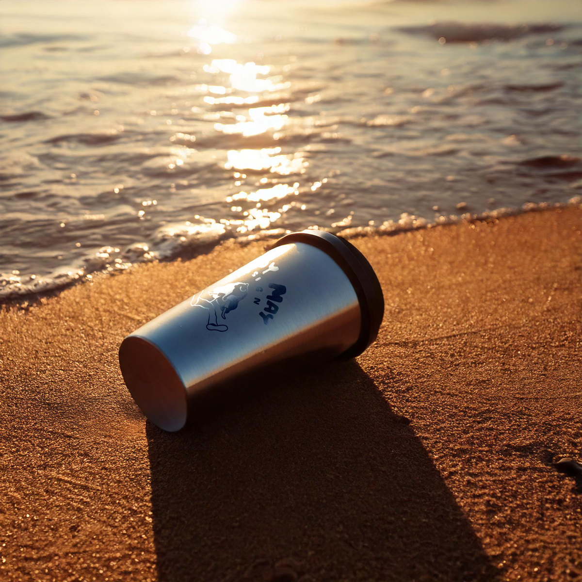 engraved-coffee-tumbler-laying-down-in-sand