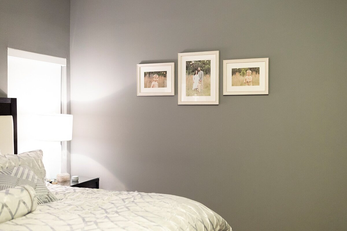 3 piece framed gallery with family photos in the master bedroom in Miami