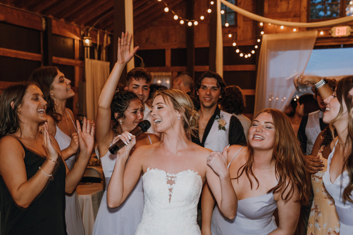 Bride singing into mic in a crowd