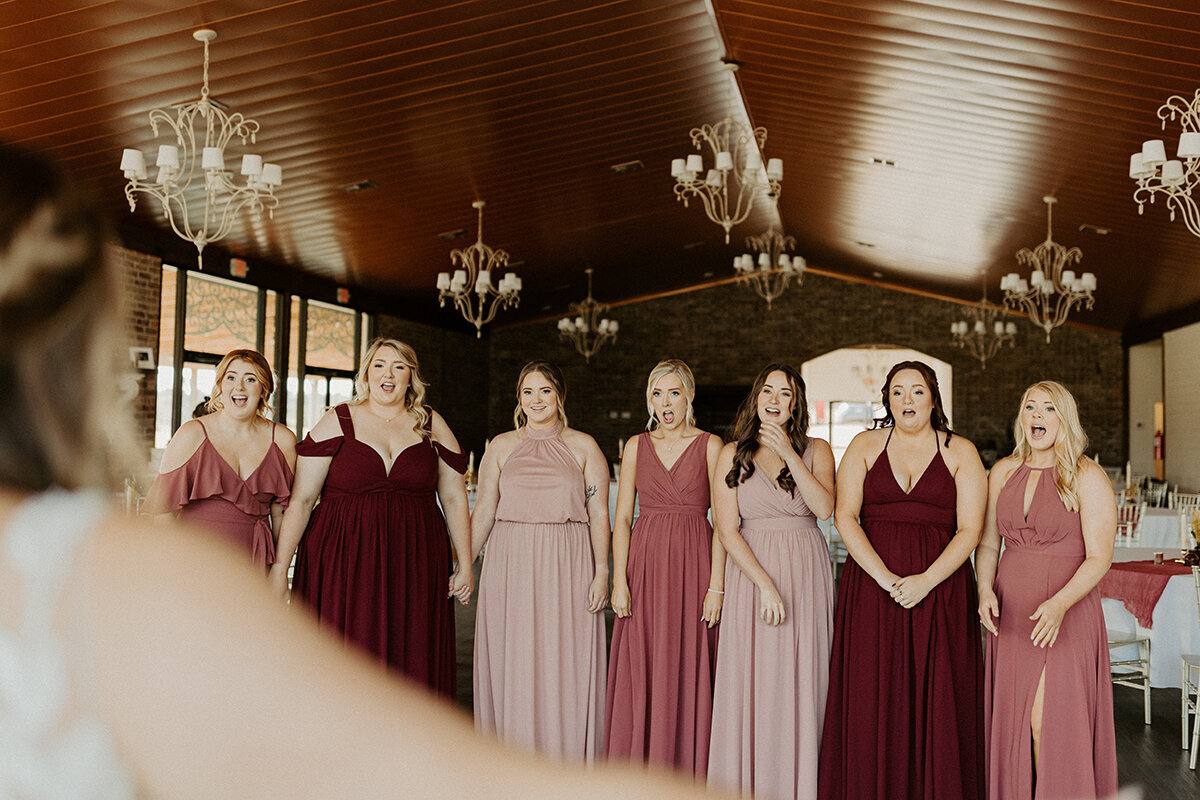 The bride's first look with her bridesmaids at the Carriage House in Magnolia, Arkansas