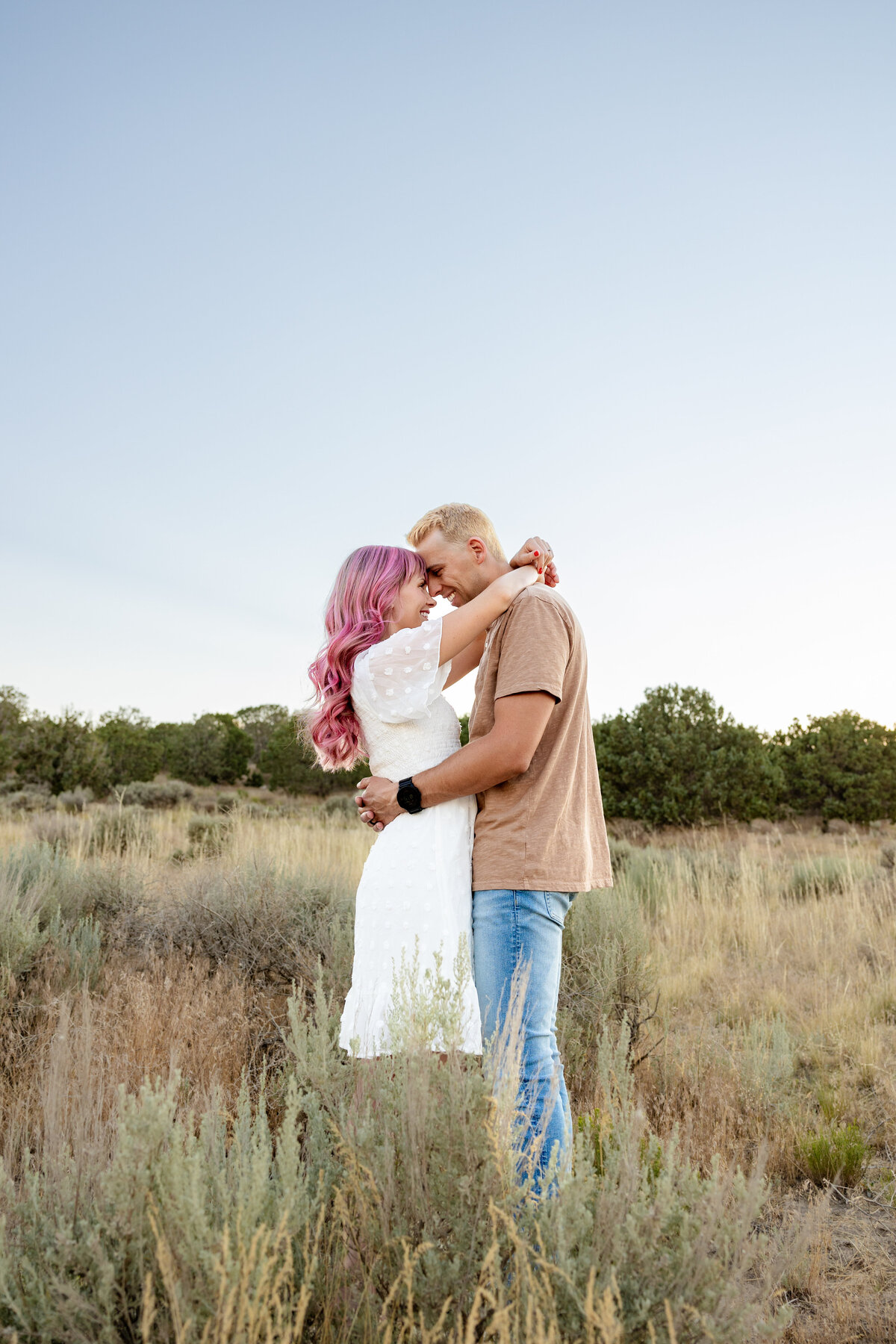 Husband and wife gaze into each others eyes while enjoying being surround by the desert of Eagle Mountain Utah