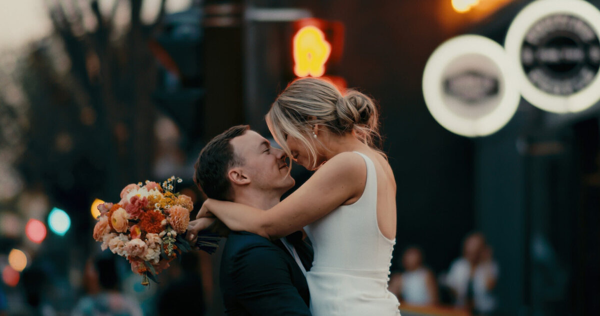 Bride and groom kissing downtown, captured by Prairie Orchid Weddings, wedding videographers in Lethbridge, Alberta. Featured on the Bronte Bride Vendor Guide.