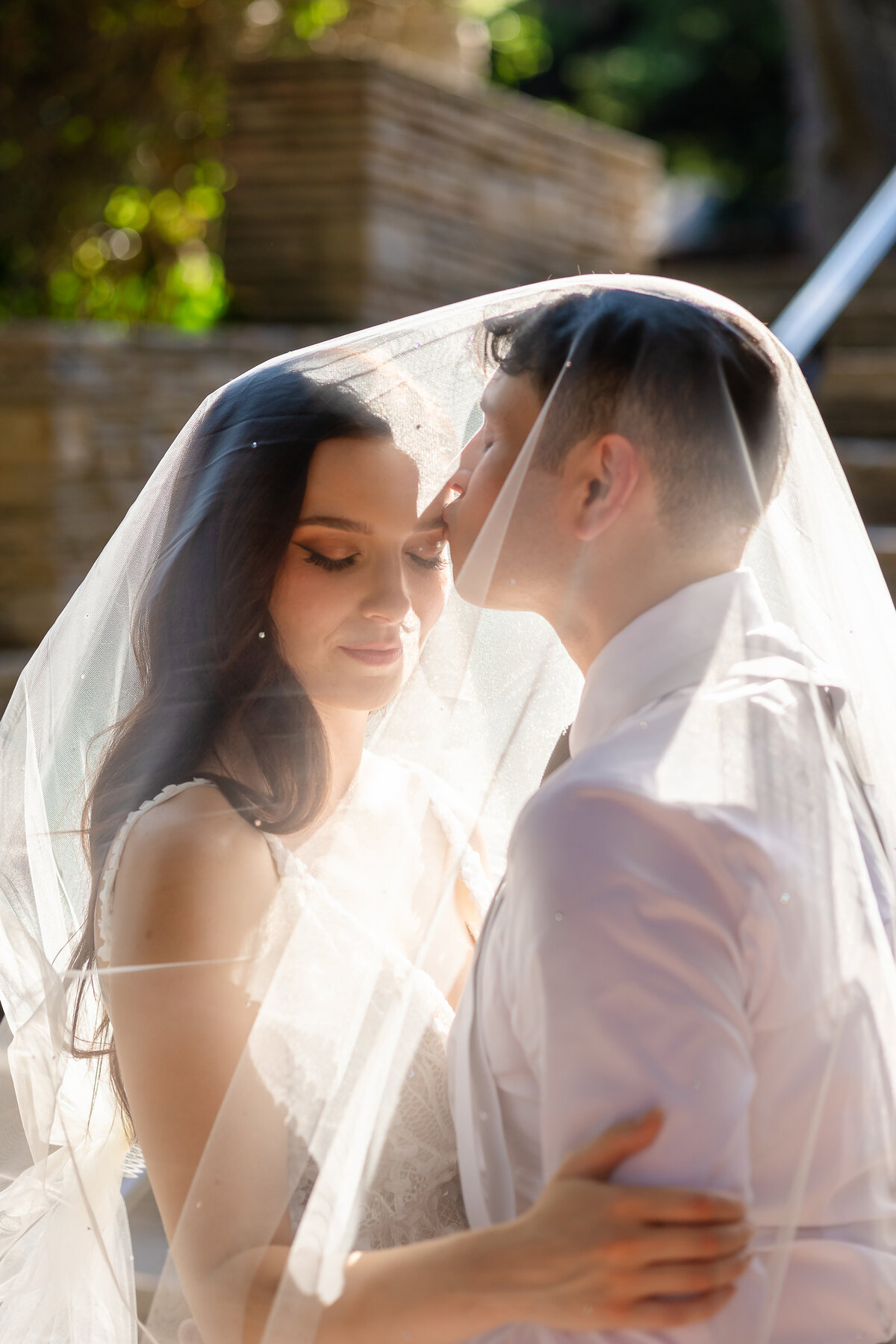 Groom kissing his bride forhead lovely moment
