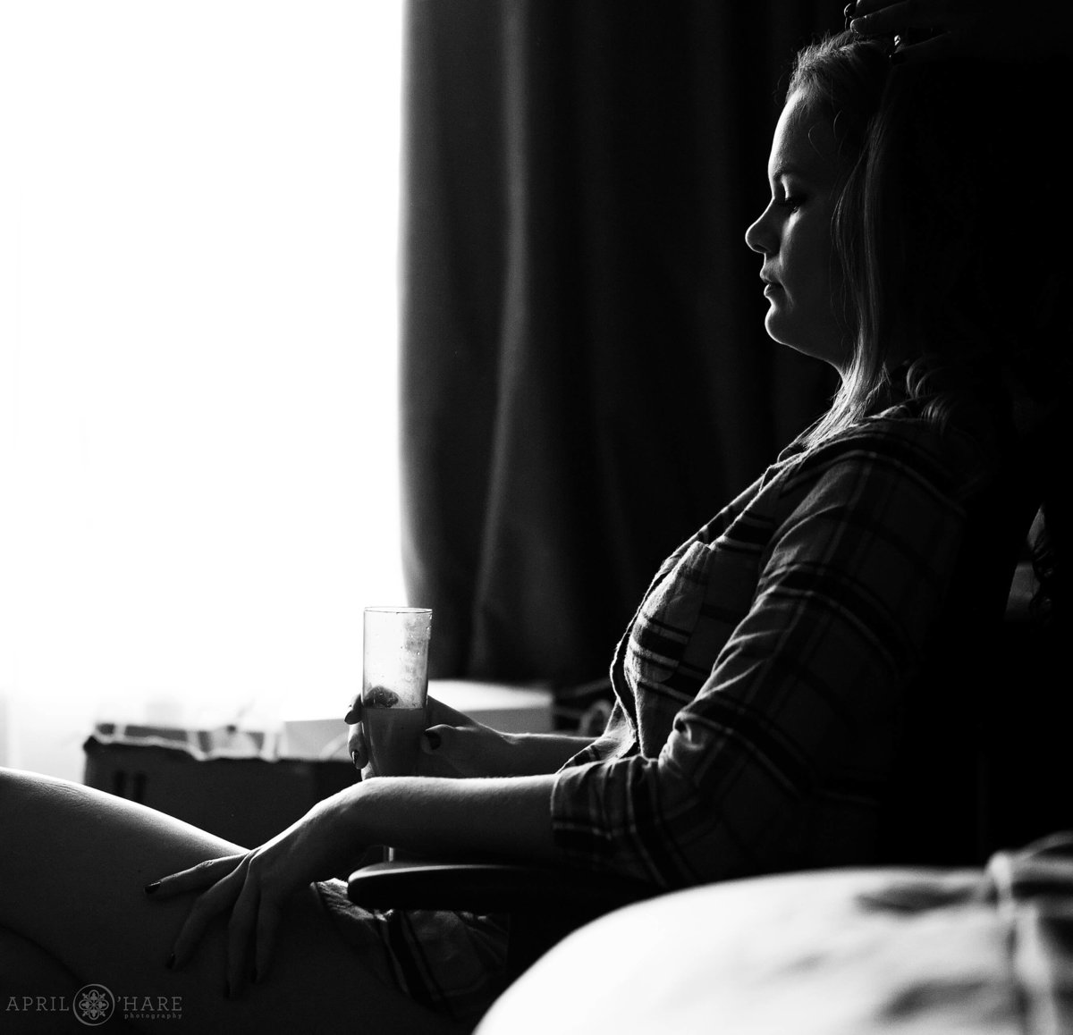 Beautiful light on bride getting hair done in her hotel room in Colorado