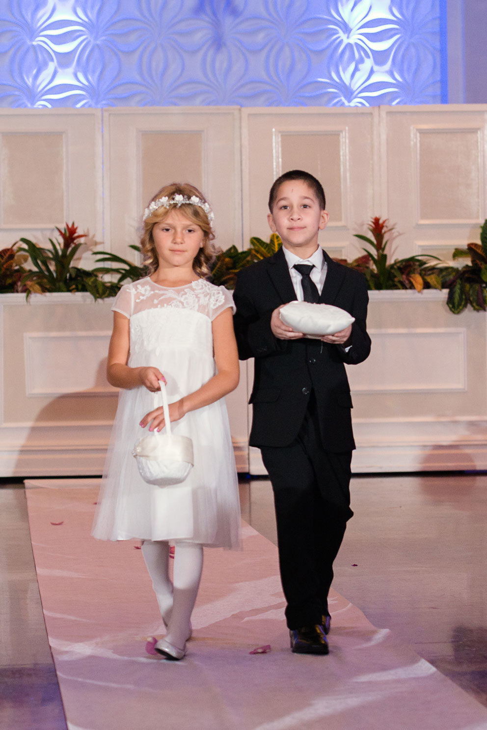 Flower girl and ring bearer walking down the aisle at The Somerley