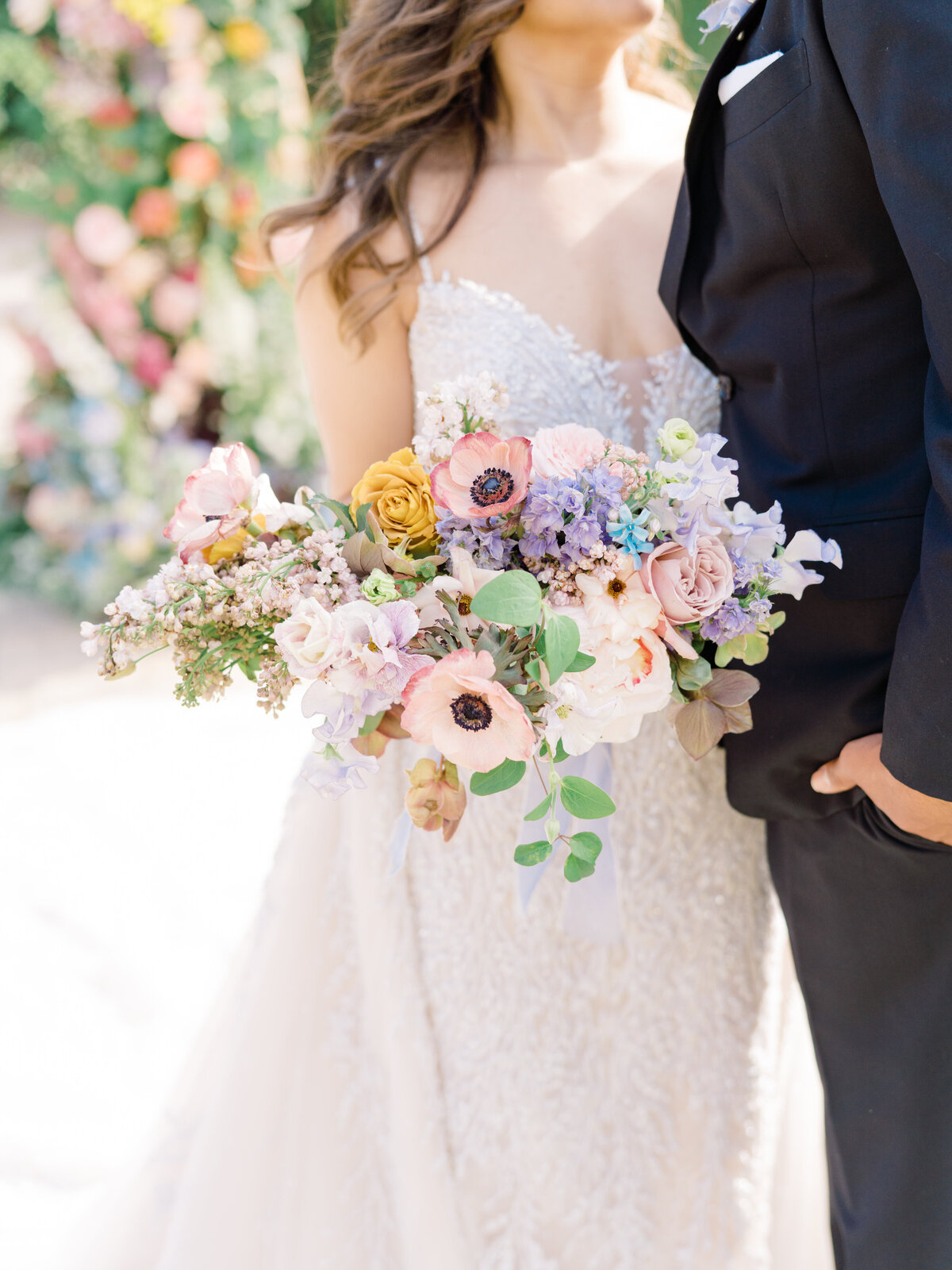bridal bouquet with pink poppies and purple, blue, and yellow flowers