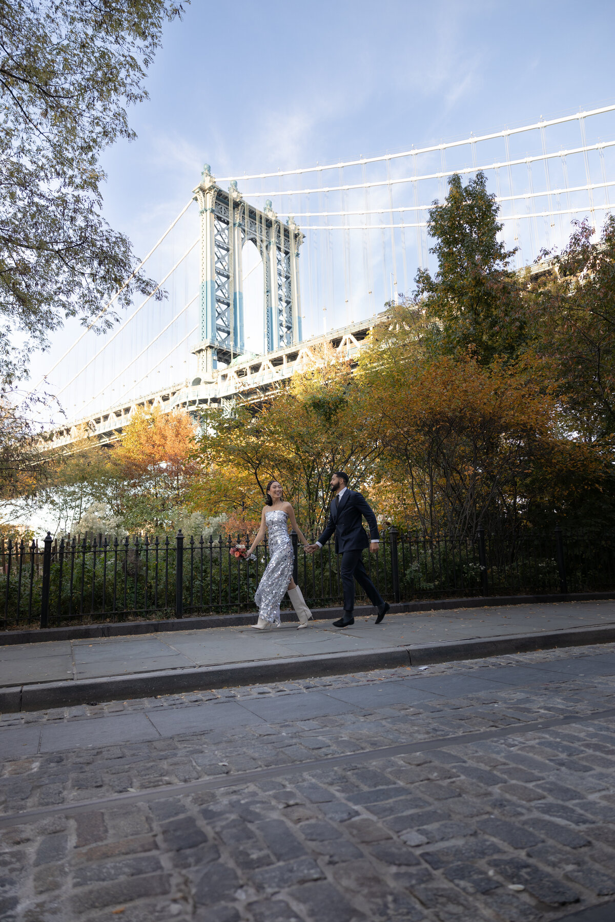 A modern, editorial-style elopement shot with the couple walking along the cobblestone streets of Brooklyn.