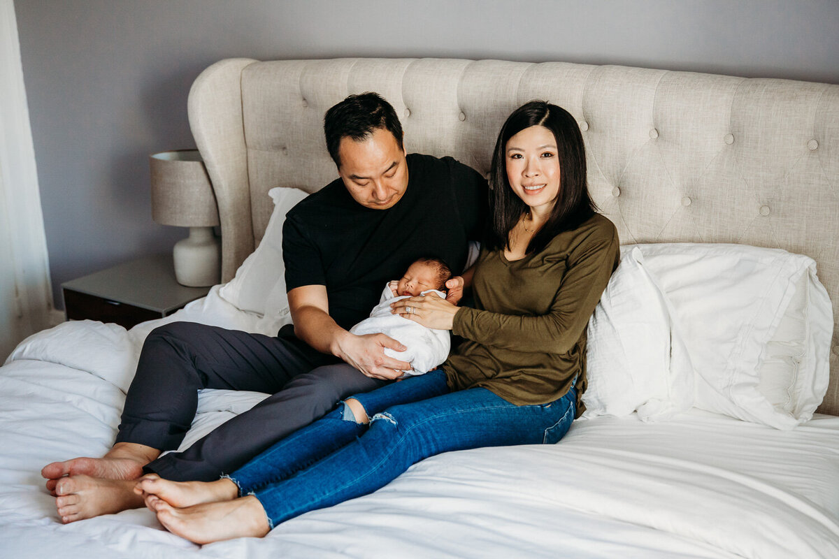 Newborn family portrait on bed