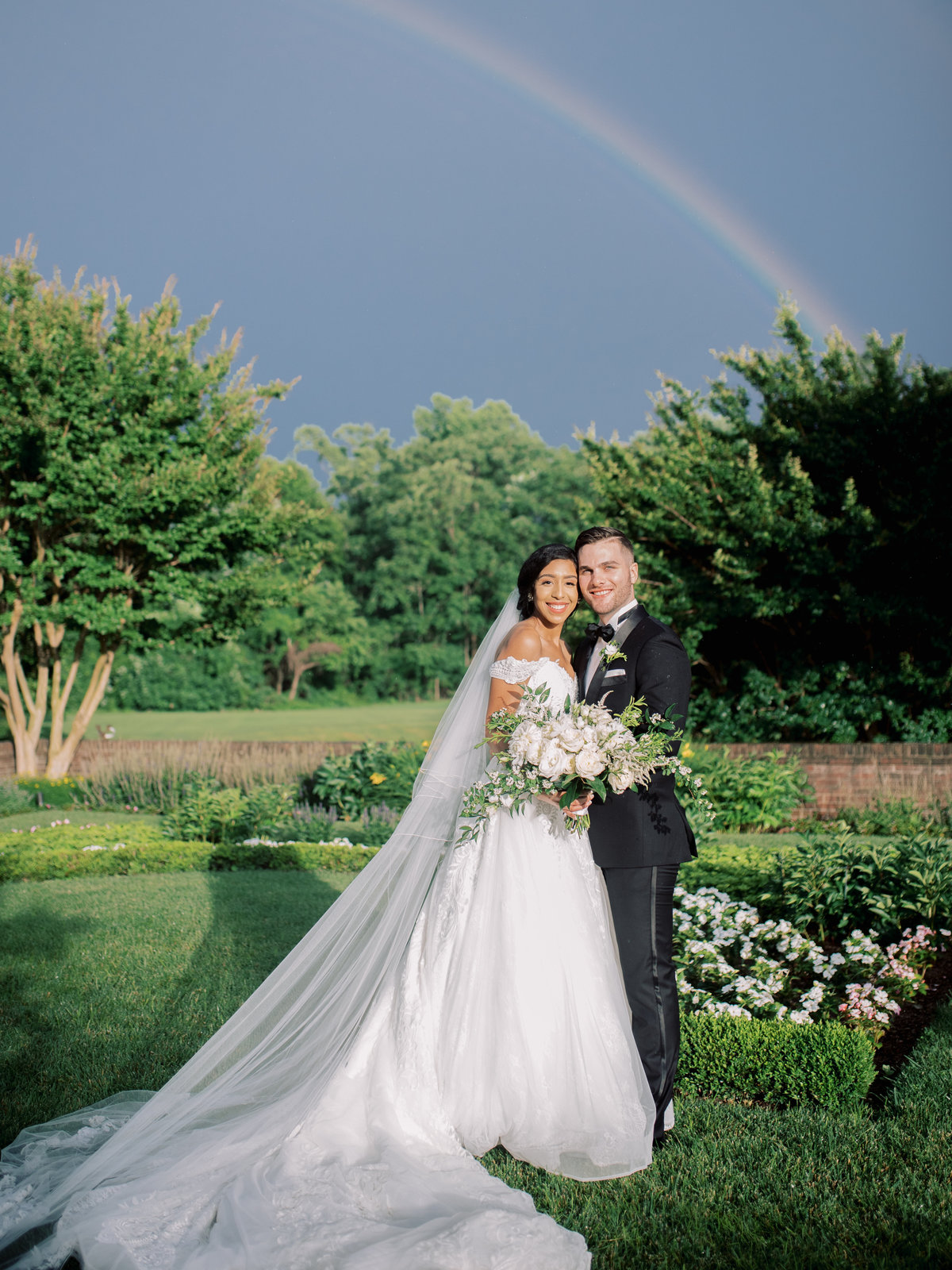 Bride and groom in front of a rainbow at Oxon Hill Manor, Maryland