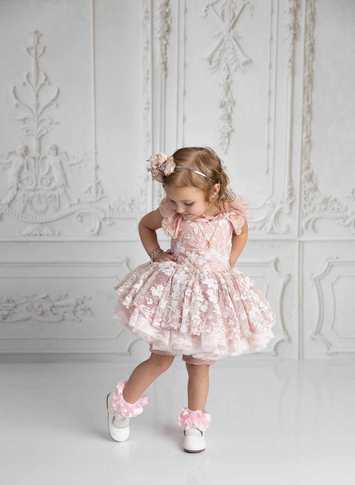 Elegant child candid portrait cwith gown and headband in La Vernia studio